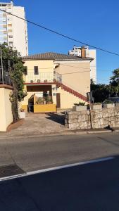 a building with a balcony on the side of a street at Guesthouse Gasho in Rijeka +4 photos