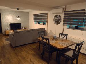 a living room with a table and a couch at Kod Dida in Gospić