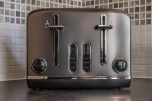 a toaster oven sitting on top of a counter at Luxury 2-bedroom 2-bathroom city centre apartment in Lichfield