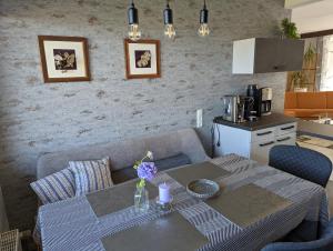 a living room with a table and a couch at Panoramalounge in Porta Westfalica