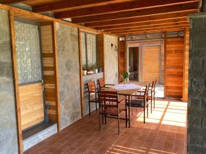 a porch with a table and chairs on a patio at Farm SuLove in Langozaj