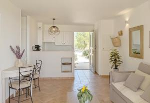 a living room with a couch and a table at ALLURA GOLF APPARTEMENT in Saumane-de-Vaucluse