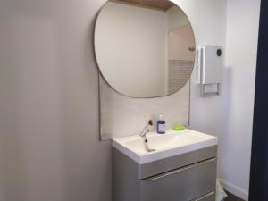 a bathroom with a sink and a mirror at Gabrielle 40m2, Netflix in Sainte-Savine