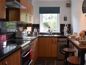 a kitchen with a sink and a dishwasher at Tree Tops in Crieff