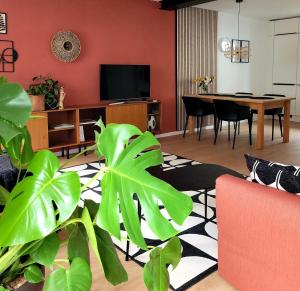 a living room with a couch and a dining room at Ferienwohnung Anna Maria Erding in Erding