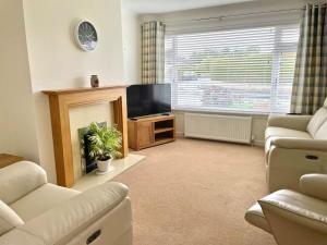 a living room with a flat screen tv and a couch at 'Edgewood' - detached bungalow in Inverness
