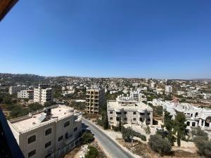 an aerial view of a city with white buildings at Alfred Apartments in Ramallah