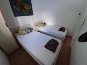 two beds in a small room with at Seafront Suites Maja in Vis