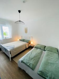 Postel nebo postele na pokoji v ubytování Gemütliche Neubauwohnung 70qm