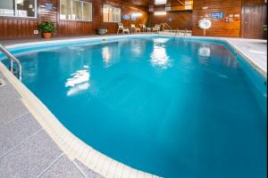 a large blue swimming pool in a building at Quality Inn & Suites in Danville