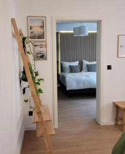 a bedroom with a bed and a ladder leading into a room at Ferienwohnung Anna Maria Erding in Erding