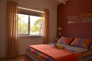 a bedroom with a bed with a window and a bed sidx sidx sidx at Cabañas Ambay in Merlo +24 photos