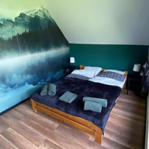 um quarto com duas camas e um quadro na parede em Stodoła Nad Skawą em Sucha Beskidzka