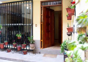 an open door with potted plants inront of it at Zans Apartments Cusco in Cusco