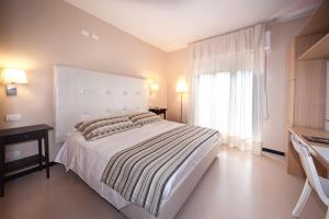 a bedroom with a large bed and a window at Hotel Carla in Levanto
