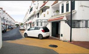 a small white car parked in front of a building at Casa Sevilla in Mairena del Aljarafe