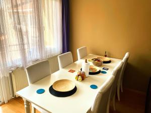 a table with chairs and a white table with hats on it at USKUDAR Home in Istanbul