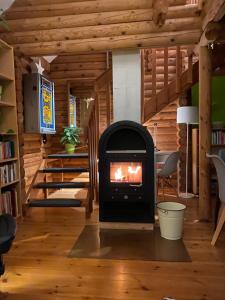 a wood stove in a room with a staircase at Eifel-Lounge BLOCKHAUS in Weilerswist