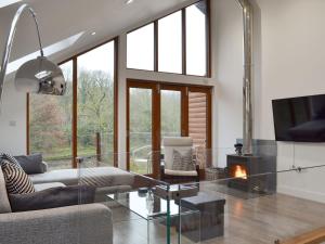 a living room with a glass table and a fireplace at Waterside Lodge Thirteen - Uk11853 in Southowram