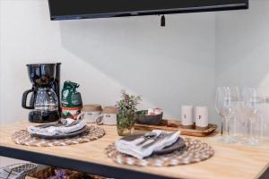 a table with napkins and wine glasses on it at Relaxing Alpaca Ranch Mins from Downtown Wimberley in Wimberley