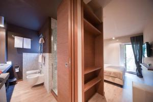a bathroom with a shower and a toilet and a sink at Hotel Carla in Levanto