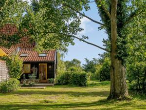 a house with a tree in front of it at Barn End Cottage in Kelsale