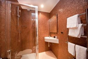 a bathroom with a shower and a toilet and a sink at Hotel Carla in Levanto