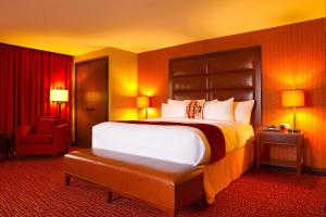 a hotel room with a large bed and a chair at Shoshone-Bannock Hotel and Event Center in Fort Hall