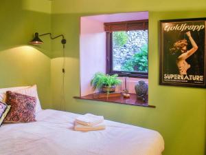 a bedroom with a bed with a mirror on the wall at Bandrake Barn in Colton