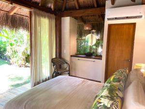a bedroom with a bed and a large window at Luxury Private Villas , Private Pool, Private garden, Jacuzzi, 24hours security in Tulum +212 photos
