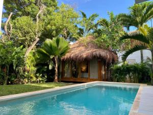 a resort with a swimming pool and a hut at Luxury Private Villas , Private Pool, Private garden, Jacuzzi, 24hours security in Tulum