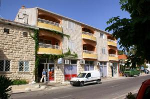 a white car parked in front of a building at Apartments by the sea Trpanj, Peljesac - 3162 in Trpanj