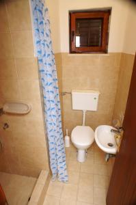 a small bathroom with a toilet and a sink at Apartments by the sea Zrnovska Banja, Korcula - 3154 in Korčula