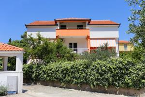 a white house with a red roof at Apartments by the sea Trpanj, Peljesac - 3157 in Trpanj