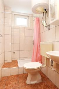 a bathroom with a toilet and a sink at Apartments by the sea Trpanj, Peljesac - 3157 in Trpanj