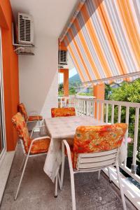 a table and chairs on the balcony of a house at Apartments by the sea Trpanj, Peljesac - 3157 in Trpanj