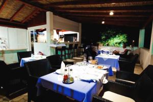 a restaurant with tables and chairs with people sitting at them at Rooms by the sea Zuljana, Peljesac - 3163 in Žuljana