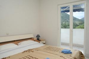 a bedroom with a bed and a large window at Apartments and rooms by the sea Zuljana, Peljesac - 3164 in Žuljana