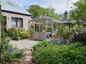 a greenhouse in the garden of a house at Middle Lodge in Mintlaw