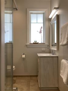 baño con lavabo, espejo y ventana en Cashmere Hills B&B en Christchurch