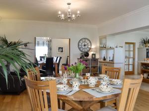 a dining room and living room with a table and chairs at Yonderton House - Uk11181 in Hollybush