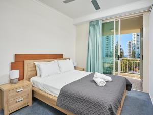 a bedroom with a large bed and a balcony at Maldives Resort Main Beach, Gold Coast in Gold Coast