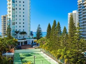 a tennis court in a city with tall buildings at Maldives Resort Main Beach, Gold Coast in Gold Coast