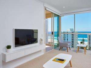a living room with a tv and a balcony with the ocean at Maldives Resort Main Beach, Gold Coast in Gold Coast +22 photos