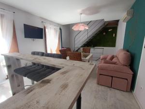 a living room with a wooden table and chairs at Encanto. Céntrico tríplex cerca de la Corredera y casco antiguo. in Córdoba