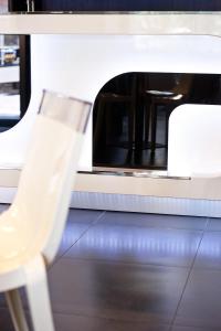 a white chair sitting in front of a oven at Hotel Carla in Levanto