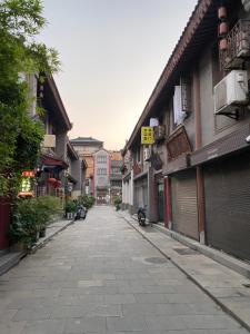 an empty street in an asian city with buildings at Ancient City Wall Home Apartment Xi'an in Xi'an