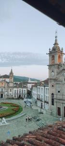 a building with a clock tower in a courtyard at Vila Santa Cruz Guest House in Braga +92 photos