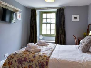 a bedroom with a bed with towels on it at Ellerton House in Richmond