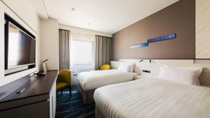 Postel nebo postele na pokoji v ubytování JR-East Hotel Mets Musashisakaii
